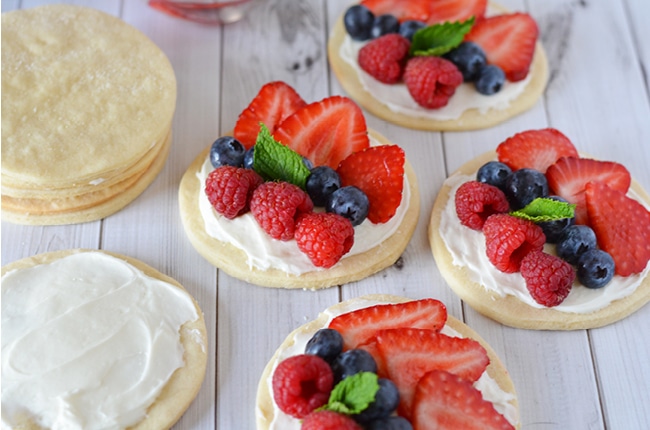 These fruit pizzas are quick and easy to make and will look gorgeous and taste amazing at your Memorial Day, Fourth of July or summer barbecue outing this summer!