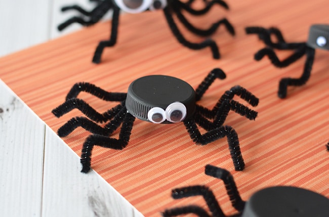 This bottle cap spider Halloween craft not only re-uses plastics in your home, it adds a friendly addition to your Halloween decor.