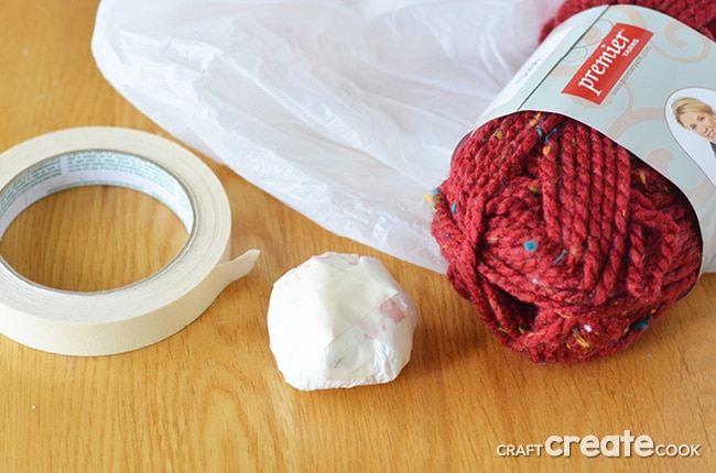 Reuse plastic shopping bags and bottle caps to make these easy and affordable homemade yarn ball ornaments.