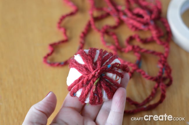 Reuse plastic shopping bags and bottle caps to make these easy and affordable homemade yarn ball ornaments.