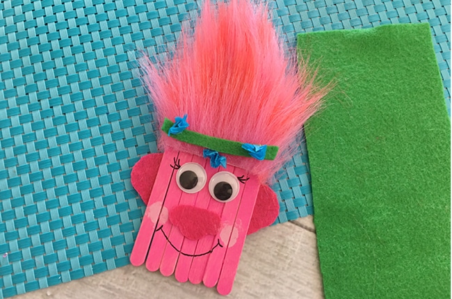 This Trolls Poppy Popsicle Stick Craft for Kids will have you thinking it's all cupcakes and rainbows in no time.