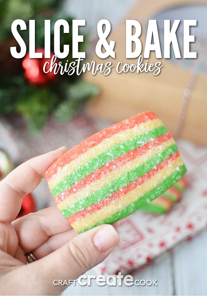 A single christmas slice and bake cookie being held up over the table with holiday decorations