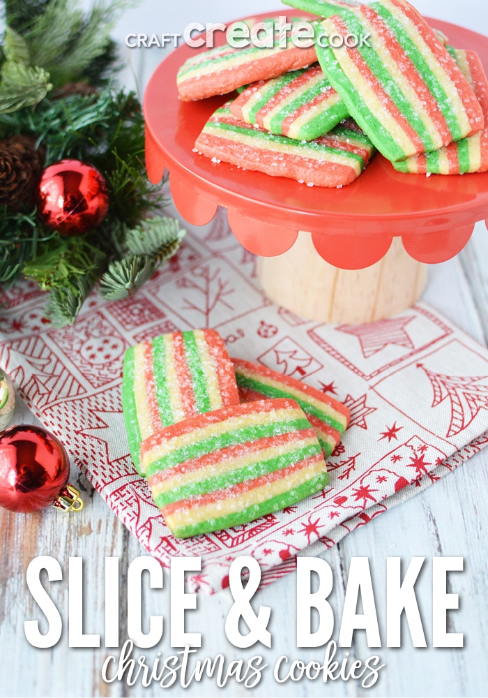 Holiday colored slice and bake cookie sitting on a holiday paper with a red cake stand in background