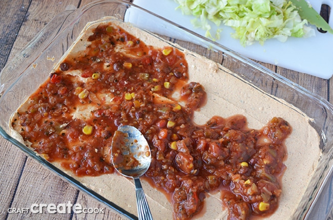 This taco dip recipe is best made the day before and will easily please a crowd!