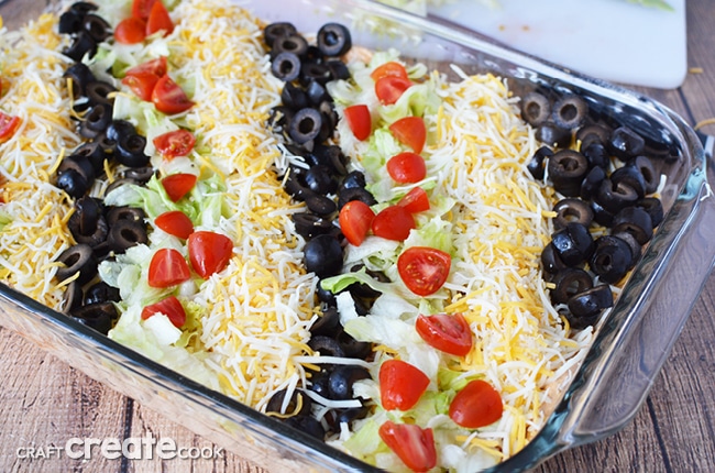 This taco dip recipe is best made the day before and will easily please a crowd!