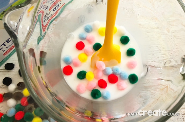 Our Sensory Slime is the perfect gooey slime with colorful pom pom balls for fun.