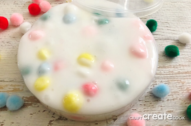 Our Sensory Slime is the perfect gooey slime with colorful pom pom balls for fun.