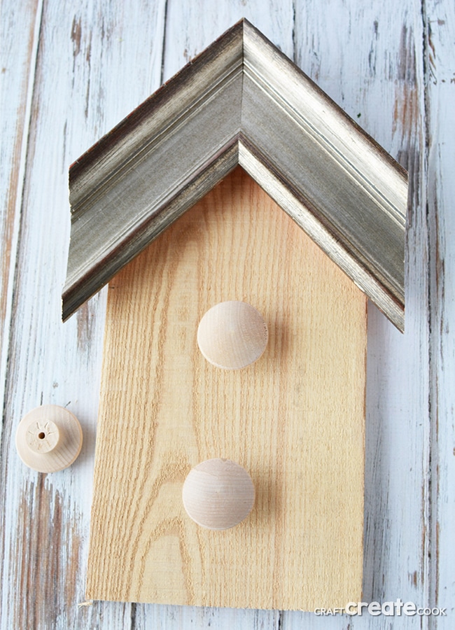 Our decorative birdhouse pallet project is a great way to reuse scrap wood and picture frames as well as add some fun to your home!