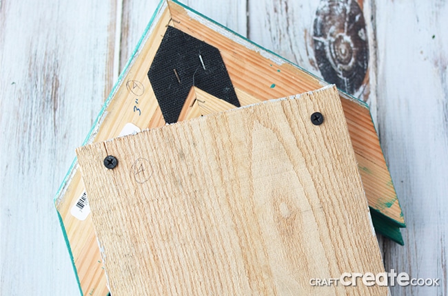 Our decorative birdhouse pallet project is a great way to reuse scrap wood and picture frames as well as add some fun to your home!