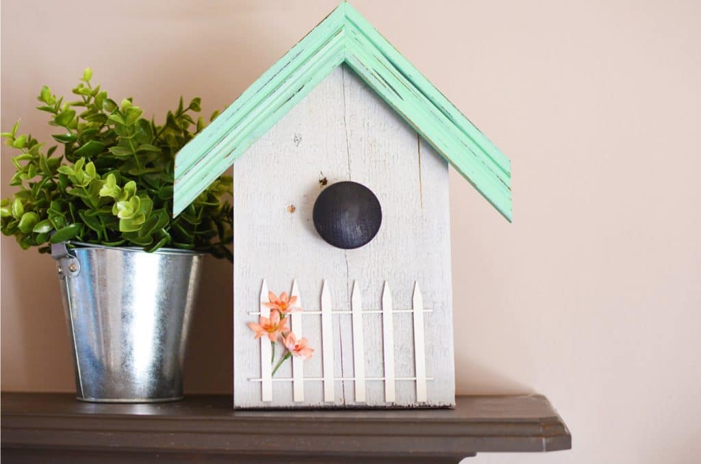 Our decorative birdhouse pallet project is a great way to reuse scrap wood and picture frames as well as add some fun to your home!