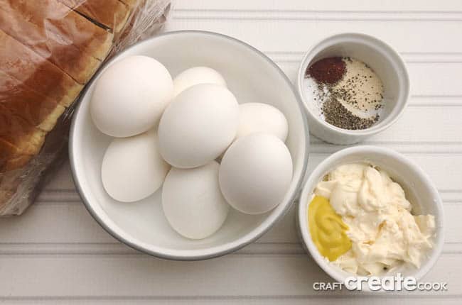 Egg Salad Sandwich Recipe ingredients placed on a desk.