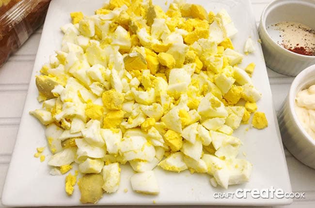 Dicing the eggs on a white desk board.