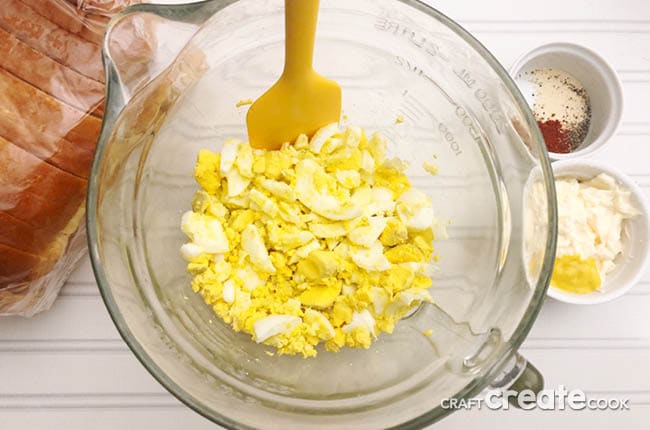 Diced eggs placed in a glass bowl.