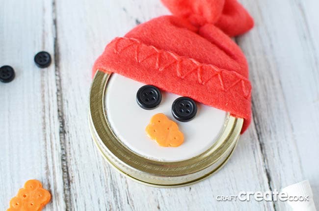 This easy to make Mason Jar Lid Snowman Ornament is so cute you'll want to make at least a dozen!