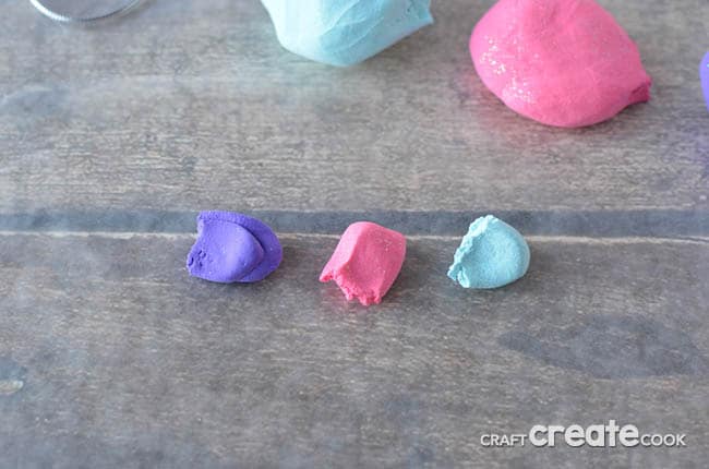 An overhead picture of modeling clay in purple pink and blue