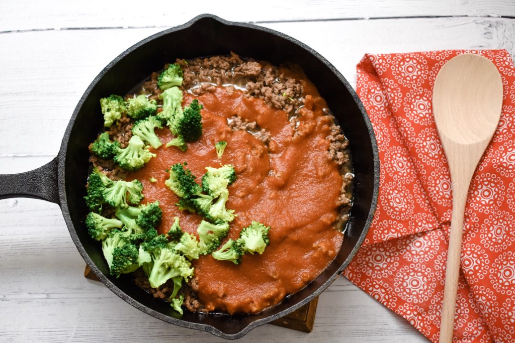 Cooked ground beef with pasta sauce and broccoli