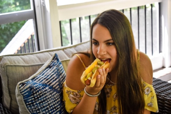 Eating finished hot dogs.