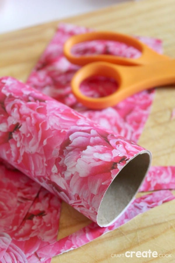 Gluing scrapbook paper to toilet paper roll