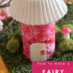 Pink cardboard fairy house on fake grass