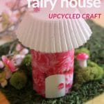 Pink cardboard fairy house on fake grass