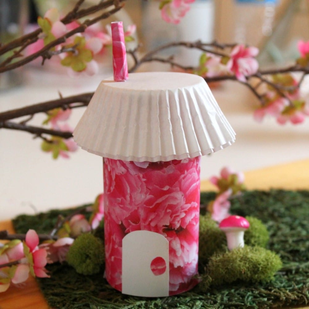 Fairy house with pink exterior and white cupcake liner roof
