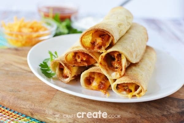 Chicken taquitos on a white plate