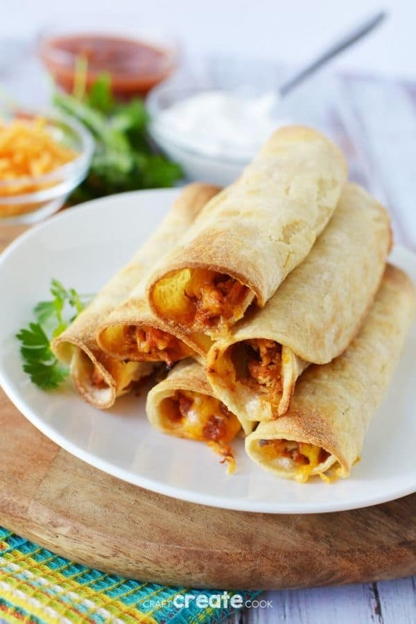 Chicken taquitos on a white plate