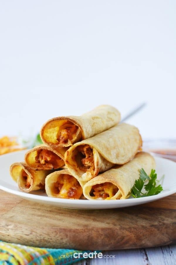 Chicken taquitos on a white plate