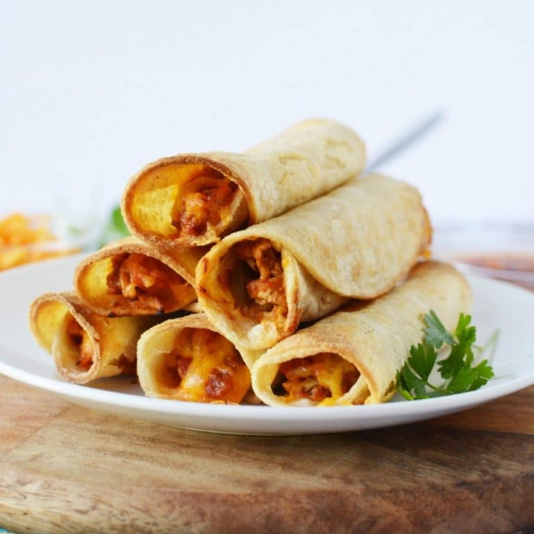 Chicken taquitos on a white plate