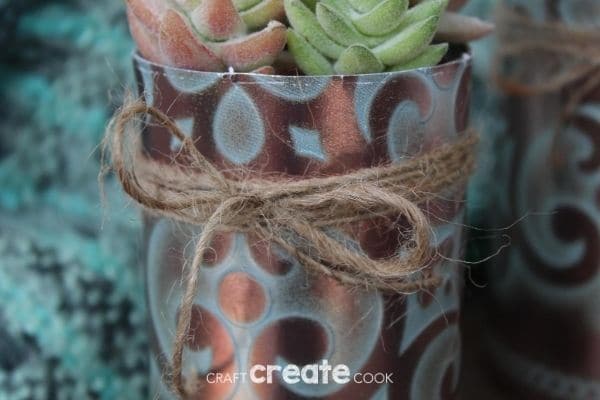 Faux copper tin can planter on wood table