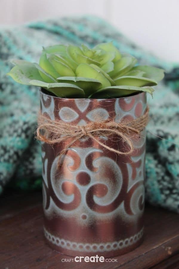 Faux copper tin can planter on wood table