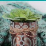Faux copper tin can planter on wood table