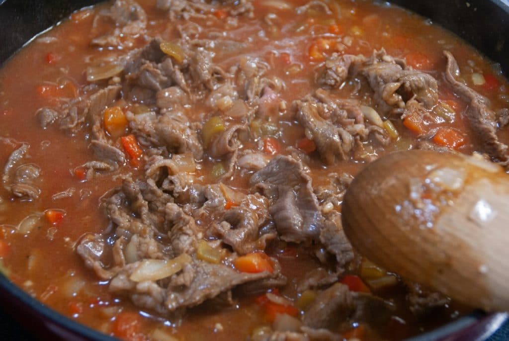 Tomato sauce in skillet with meat