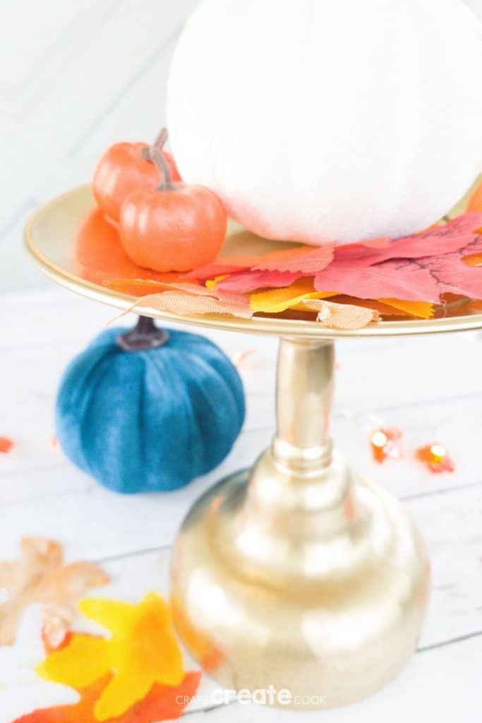 Gold stand with pumpkin and leaves