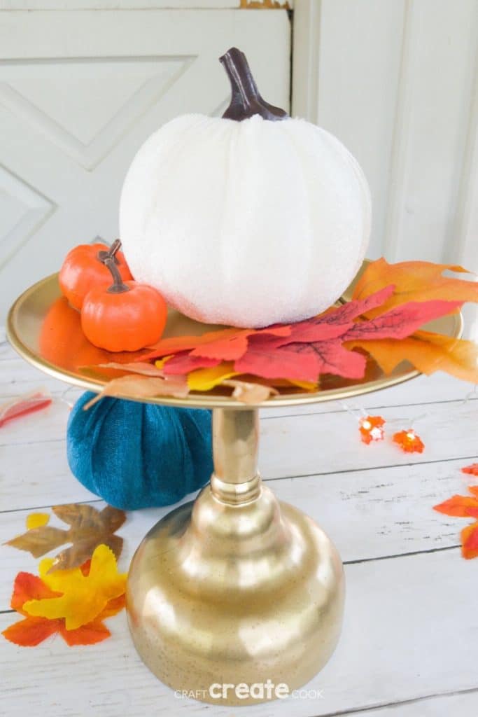 Gold stand with pumpkin and leaves