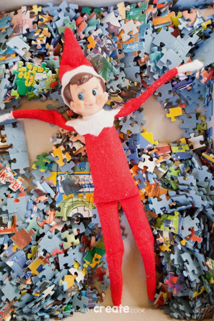 Elf on the Shelf laying in puzzle pieces