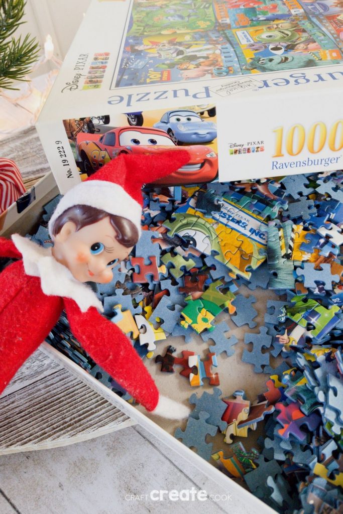 Elf on the Shelf laying in puzzle pieces