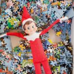 Elf on the Shelf laying in puzzle pieces