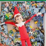 Elf on the Shelf laying in puzzle pieces