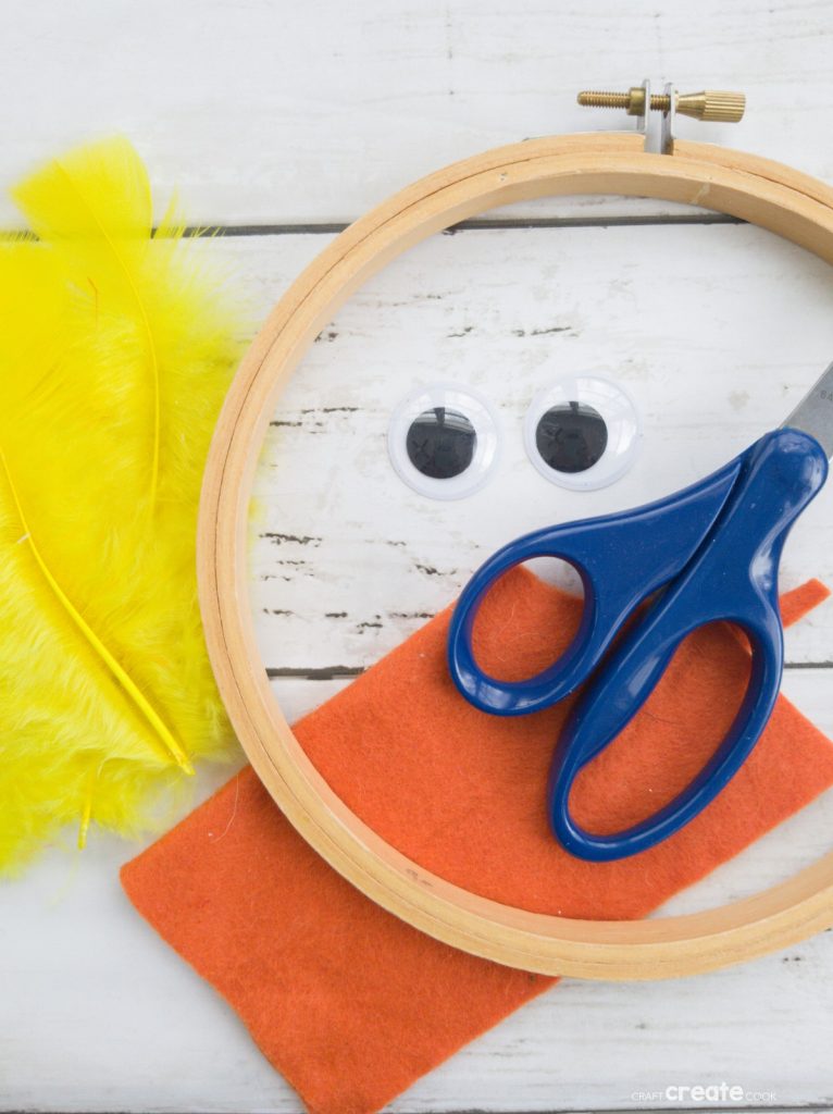 White wreath with yellow feather chicken in center