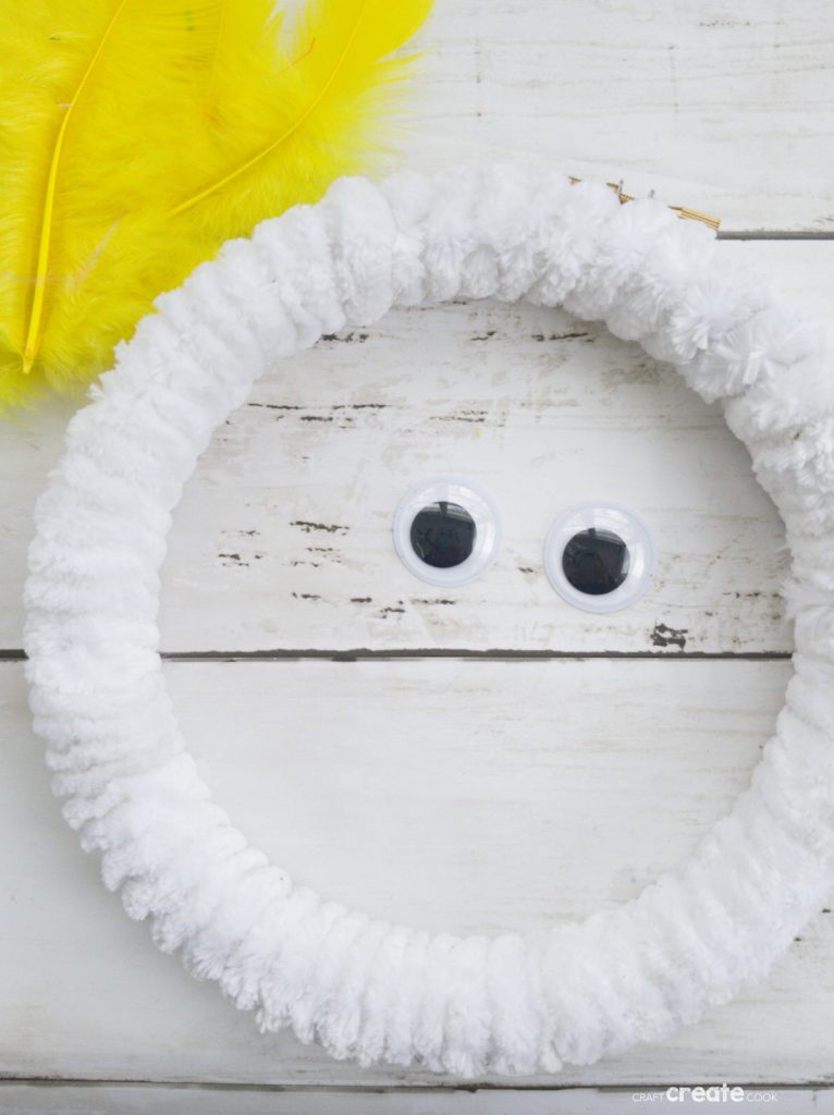 White wreath with yellow feather chicken in center