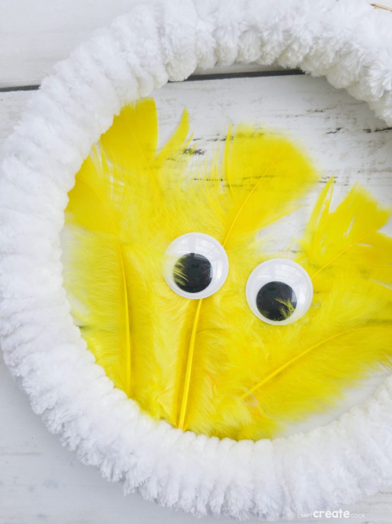 White wreath with yellow feather chicken in center