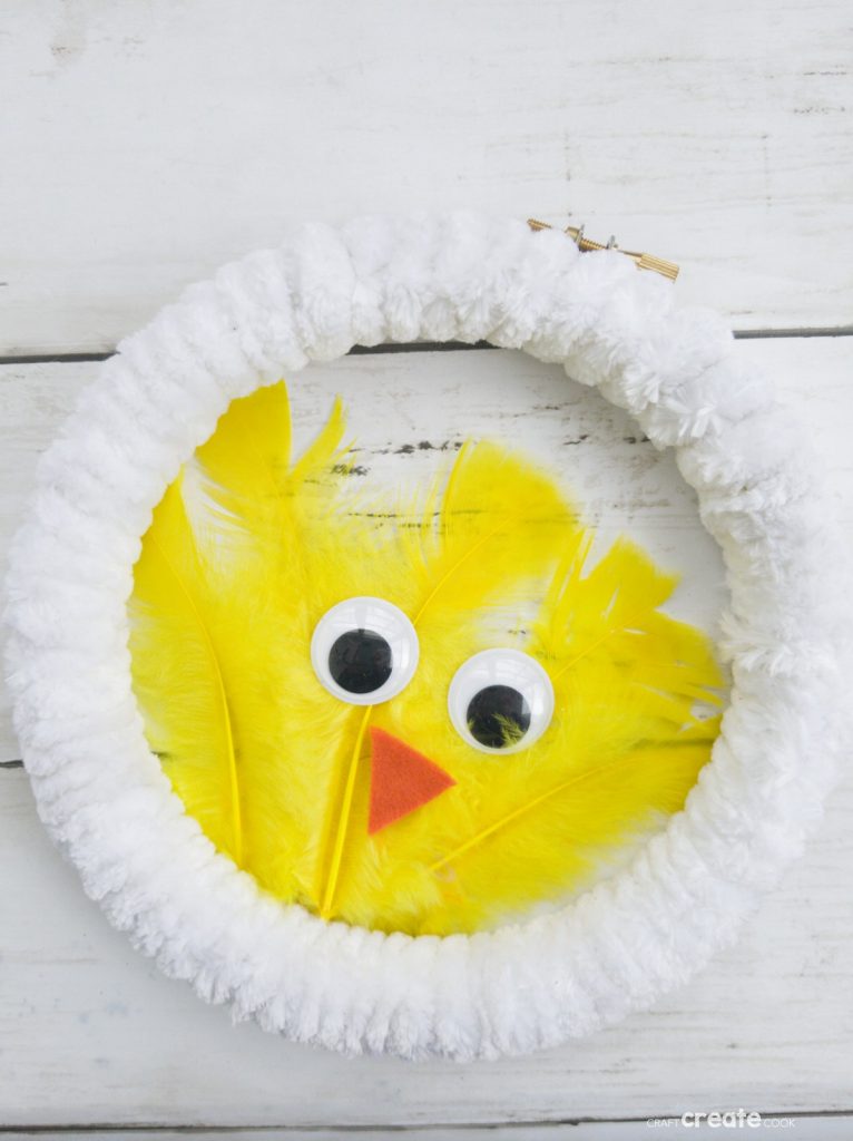 White wreath with yellow feather chicken in center
