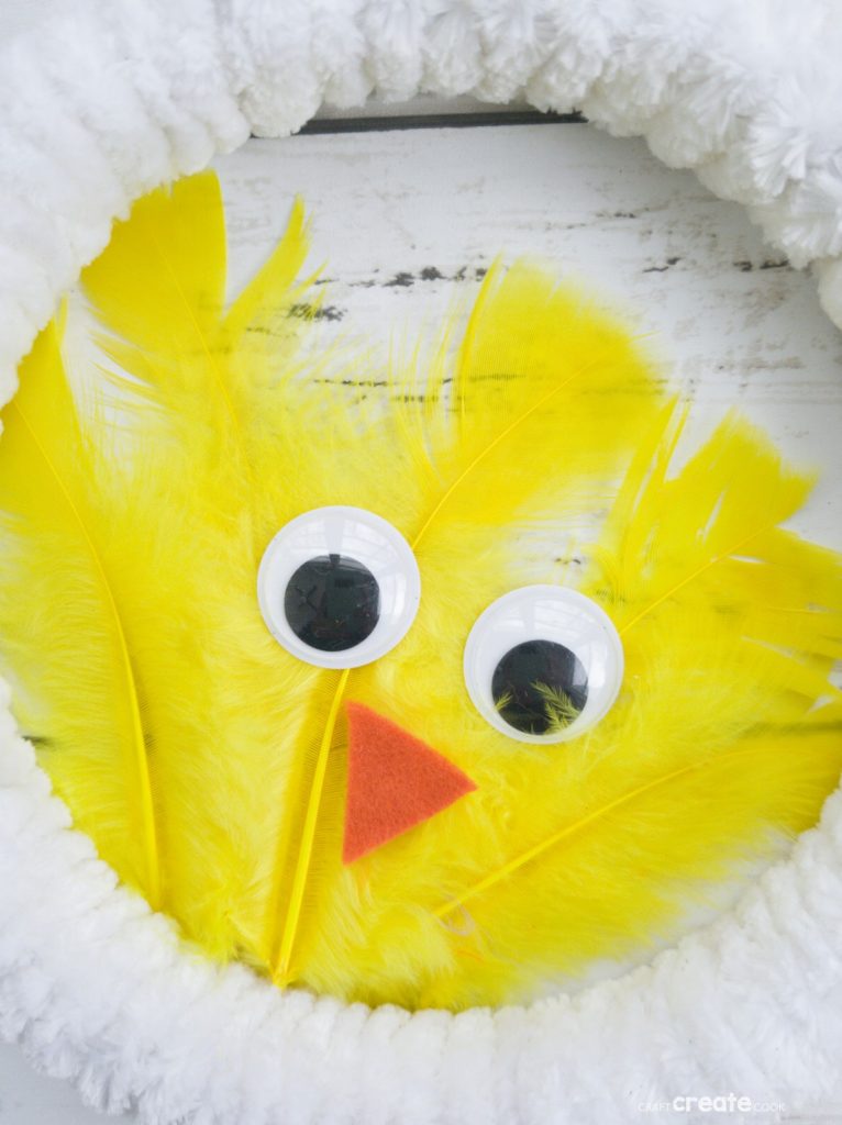 White wreath with yellow feather chicken in center