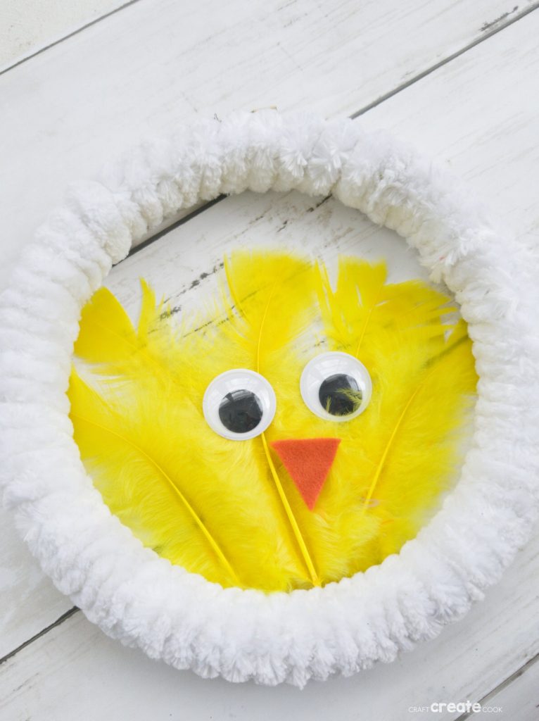 White wreath with yellow feather chicken in center