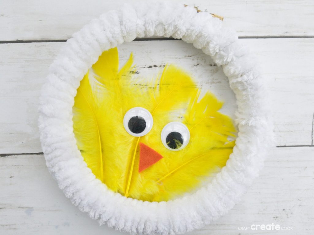 White wreath with yellow feather chicken in center