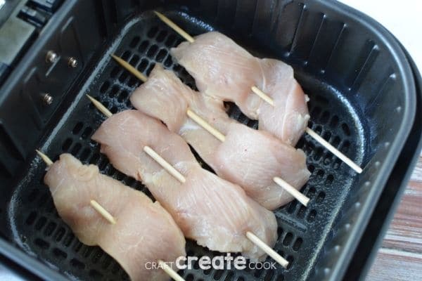 Chicken on skewers in air fryer basket