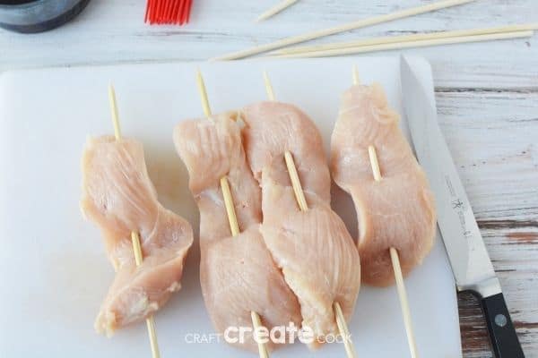 Threading chicken through skewers