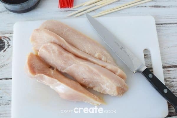 Slicing chicken brast on cutting board