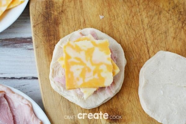 Biscuit topped with ham and cheese